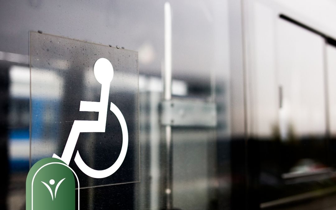 Dwie osoby siedzą przy biurku i wypełniają dokumenty o świadczenie wspierające
